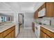 Kitchen with white appliances and wood cabinets at 5708 Bayshore Dr, Seminole, FL 33772