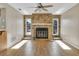 Living room with a stone fireplace and laminate flooring at 5708 Bayshore Dr, Seminole, FL 33772