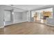 Open living room with wood-look floors and fireplace at 5708 Bayshore Dr, Seminole, FL 33772