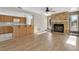 Bright living room features a stone fireplace and laminate wood floors at 5708 Bayshore Dr, Seminole, FL 33772