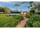 Landscaped backyard with brick path and pool at 6226 Hampton N Ct, St Petersburg, FL 33710