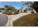 House exterior view with a curved driveway and lush landscaping at 6226 Hampton N Ct, St Petersburg, FL 33710