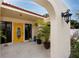 Inviting front entrance with a yellow door and arched entryway at 6226 Hampton N Ct, St Petersburg, FL 33710