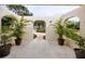 Peaceful front patio with potted plants and arched walkways at 6226 Hampton N Ct, St Petersburg, FL 33710
