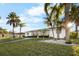 Bright white house with palm trees and canal views at 713 Gran Kaymen Way, Apollo Beach, FL 33572