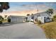 White single story home with two car garage and mature landscaping at 713 Gran Kaymen Way, Apollo Beach, FL 33572