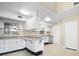 Kitchen with white cabinets, granite countertops and stainless steel appliances at 713 Gran Kaymen Way, Apollo Beach, FL 33572