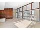 Open living room with wood wall and view into sunroom at 713 Gran Kaymen Way, Apollo Beach, FL 33572