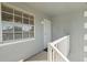 Private balcony with white railings and window at 7713 Hillside Ct # 201, Hudson, FL 34667