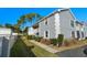 Side view of building showing gray exterior and landscaping at 7713 Hillside Ct # 201, Hudson, FL 34667