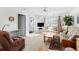 Living room with sliding glass doors to balcony, comfortable seating at 7713 Hillside Ct # 201, Hudson, FL 34667