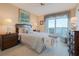 Cozy bedroom with a large bed, matching lamps, and a waterfront view at 7963 Sailboat Key S Blvd # 408, South Pasadena, FL 33707