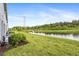 Landscaped backyard with pond view and lush greenery at 8321 Wildflower Glen Ave, Odessa, FL 33556