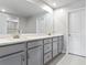 Elegant bathroom with double vanity and large mirror at 8321 Wildflower Glen Ave, Odessa, FL 33556