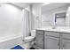 Clean bathroom with gray vanity and a shower/tub combo at 8321 Wildflower Glen Ave, Odessa, FL 33556