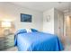Bright bedroom with a blue comforter and built-in dresser at 8321 Wildflower Glen Ave, Odessa, FL 33556