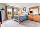 Spacious bedroom with a wooden bed frame and large windows at 8321 Wildflower Glen Ave, Odessa, FL 33556