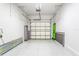 Spacious garage with an open door and extra storage at 8321 Wildflower Glen Ave, Odessa, FL 33556