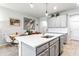 Modern kitchen with gray cabinets, stainless steel appliances, and a quartz island at 8321 Wildflower Glen Ave, Odessa, FL 33556