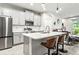 Modern kitchen with gray cabinets, stainless steel appliances, and quartz countertops at 8321 Wildflower Glen Ave, Odessa, FL 33556