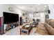 Spacious living room with large TV, comfortable seating, and open floor plan at 8321 Wildflower Glen Ave, Odessa, FL 33556