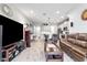Open concept living room and kitchen with leather furniture and hardwood floors at 8321 Wildflower Glen Ave, Odessa, FL 33556