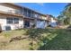 Townhome backyard with patio, screened balcony, and grassy area at 8954 Antigua Dr, Seminole, FL 33777