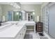 Double vanity bathroom with a large mirror and glass block shower at 8954 Antigua Dr, Seminole, FL 33777