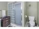 Bathroom with glass block shower and toilet at 8954 Antigua Dr, Seminole, FL 33777