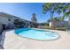 Community pool with surrounding patio furniture at 8954 Antigua Dr, Seminole, FL 33777