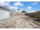 Large backyard with mostly dirt and a wooden fence at 9608 Richwood Ln, Port Richey, FL 34668