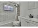 Clean bathroom with subway tile and white vanity at 9608 Richwood Ln, Port Richey, FL 34668