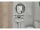 Bathroom with pedestal sink, toilet, and glass shelf at 9608 Richwood Ln, Port Richey, FL 34668