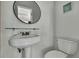 Small bathroom with pedestal sink, toilet and shelf at 9608 Richwood Ln, Port Richey, FL 34668