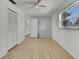 Bedroom with wood floor and access to another room at 9608 Richwood Ln, Port Richey, FL 34668