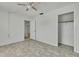 Bedroom featuring tile floors, a closet, and access to another room at 9608 Richwood Ln, Port Richey, FL 34668