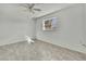 Bright bedroom with tile flooring, ceiling fan, and a window at 9608 Richwood Ln, Port Richey, FL 34668