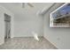 Bedroom with tile floor, ceiling fan, window, and closet at 9608 Richwood Ln, Port Richey, FL 34668