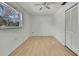 Bedroom with wood floors and large window at 9608 Richwood Ln, Port Richey, FL 34668