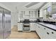 Updated kitchen with stainless steel appliances and white cabinets at 9608 Richwood Ln, Port Richey, FL 34668