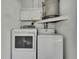 Laundry room with washer, dryer, and overhead cabinets at 9608 Richwood Ln, Port Richey, FL 34668