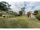 Spacious backyard with grassy area and partial fence at 102 Stafford Dr, Palm Harbor, FL 34684