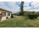 Large backyard with grassy area and privacy hedges at 102 Stafford Dr, Palm Harbor, FL 34684