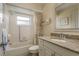 Clean bathroom with granite countertop, shower, and tub at 102 Stafford Dr, Palm Harbor, FL 34684