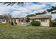 Rear view of house showcasing patio and backyard at 102 Stafford Dr, Palm Harbor, FL 34684