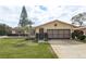 House exterior featuring a well-maintained lawn and attached garage at 102 Stafford Dr, Palm Harbor, FL 34684