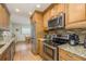 Kitchen features stainless steel appliances and wood cabinets at 102 Stafford Dr, Palm Harbor, FL 34684
