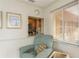 Living room features a comfy chair and kitchen pass-through at 102 Stafford Dr, Palm Harbor, FL 34684