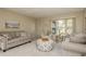 Living room featuring neutral colored couches and a coffee table at 102 Stafford Dr, Palm Harbor, FL 34684