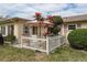 Enclosed patio with white picket fence and lush plants at 102 Stafford Dr, Palm Harbor, FL 34684